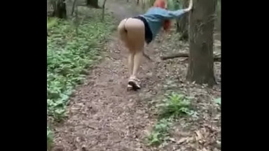 Redheaded beauty RitaFox walks in the woods and shows her privates